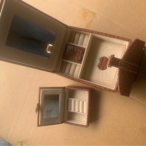 Brown croc leather travel jewelry case with handle.